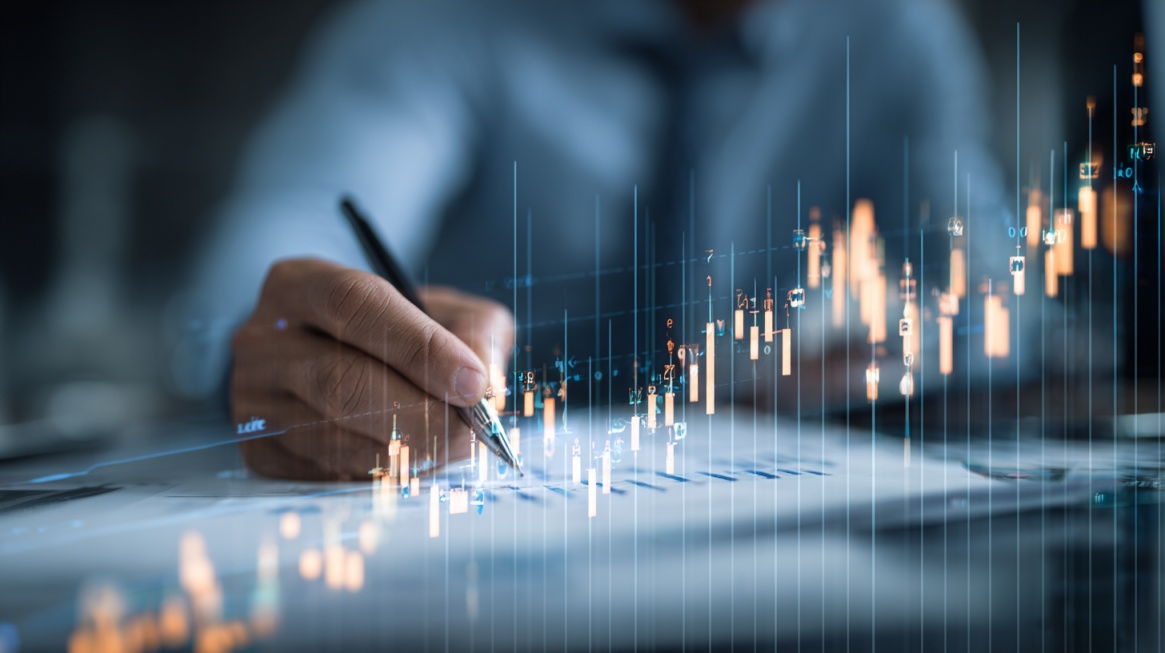 Close-up of a professional analyzing financial charts and market data